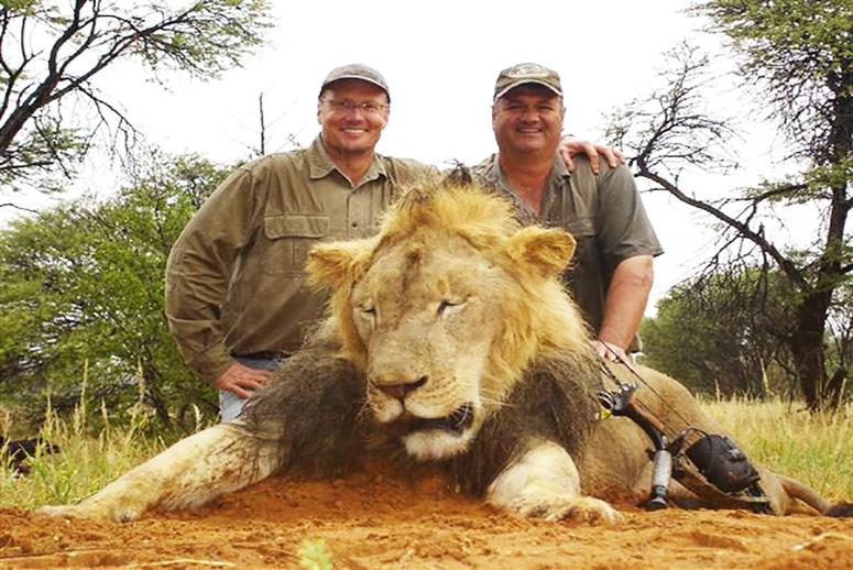 Walter Palmer (L) pictured here posing with another lion he killed before illegally killing Cecil (not pictured) Source:Facebook